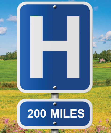 a hospital road sign that says 200 miles in a rural setting