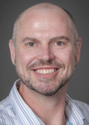 A portrait of Andrew Greazel of the Department of Occupational and Environmental Health at the University of Iowa College of Public Health.