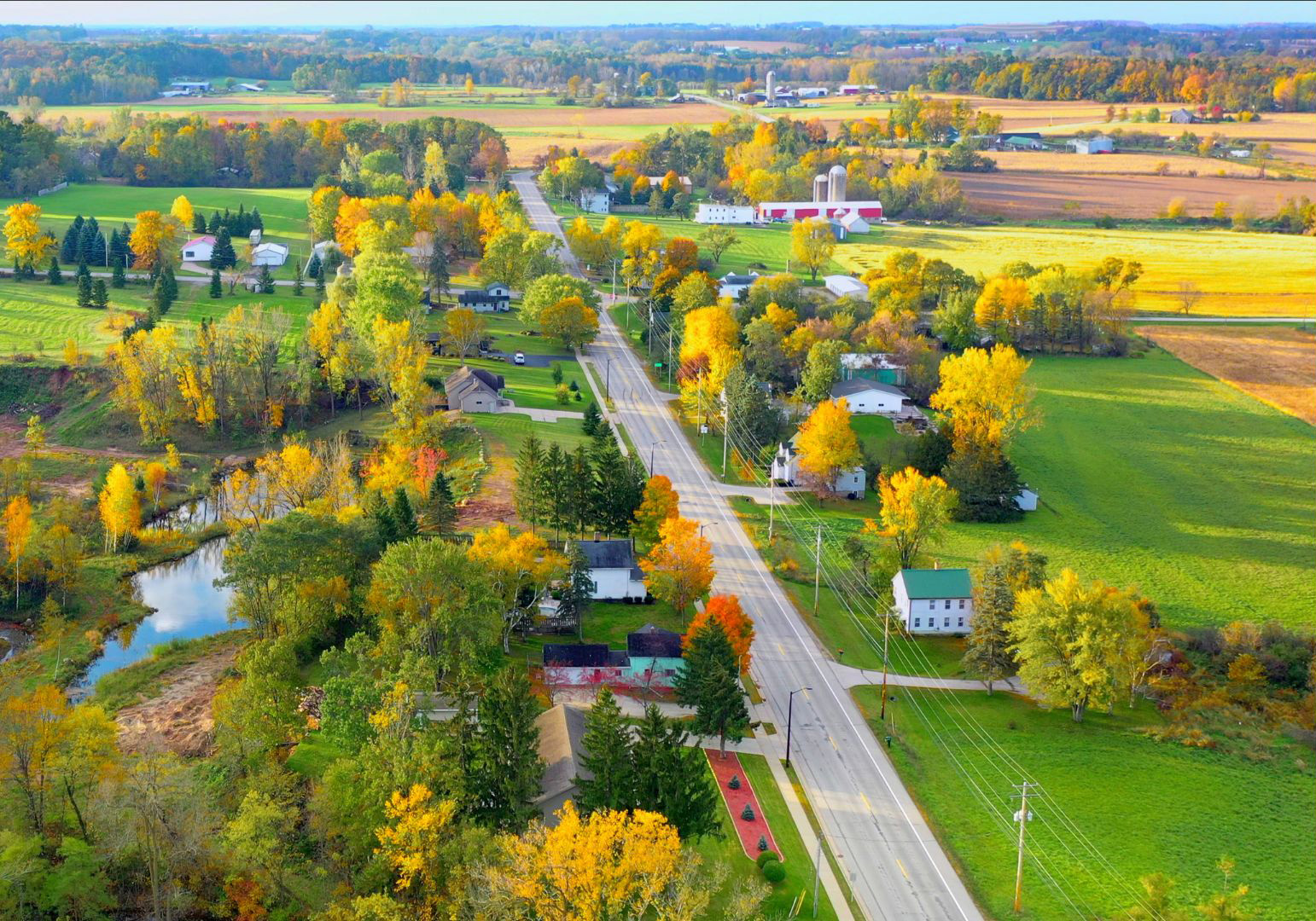 Aerial view of rural neighborhood with trees and fall colors